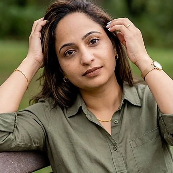 Mubeena — on a bench, hands in her hair